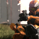A screenshot from Halo Infinite's multiplayer reveal, showing an orange-colored spartan sliding while aiming down the sights of what appears to be a pistol.